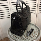 Front view of polished elevated women's handbag – women's statement bag