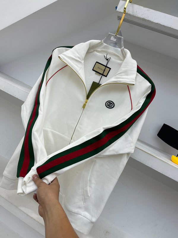 Flat lay presentation of Gucci luxury clothing with label-forward styling