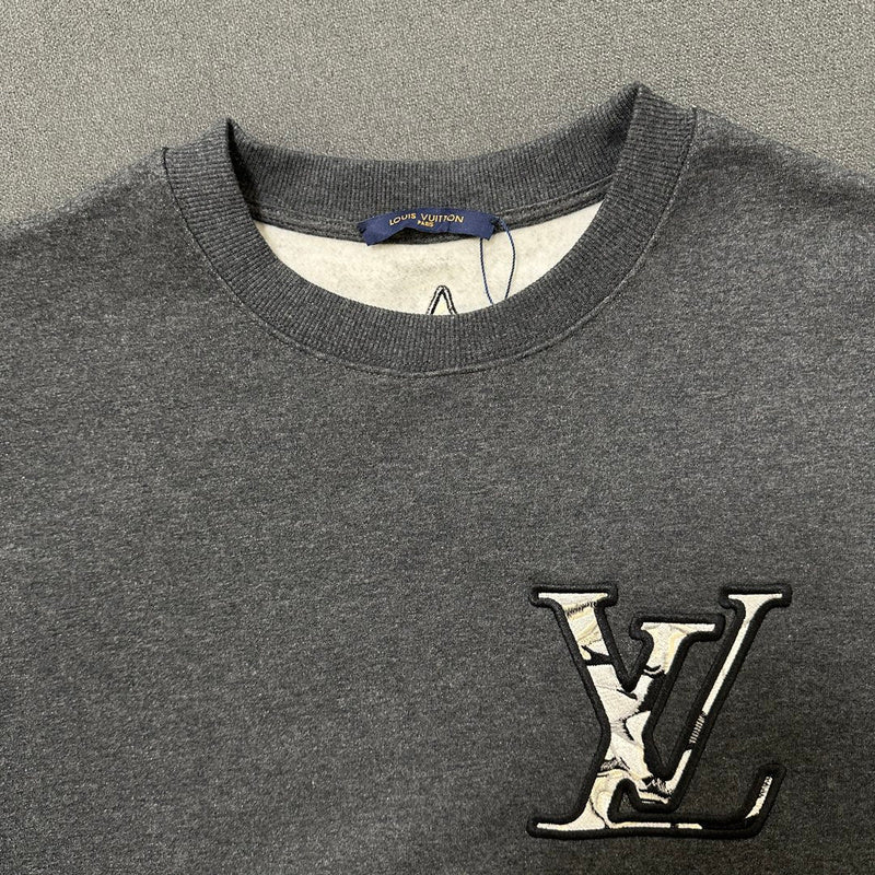 Close-up detail shot of Louis Vuitton luxury clothing with logo-detail design