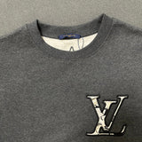 Close-up detail shot of Louis Vuitton luxury clothing with logo-detail design