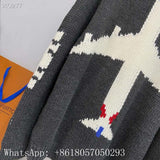 Flat lay presentation of Louis Vuitton luxury clothing with runway-inspired design