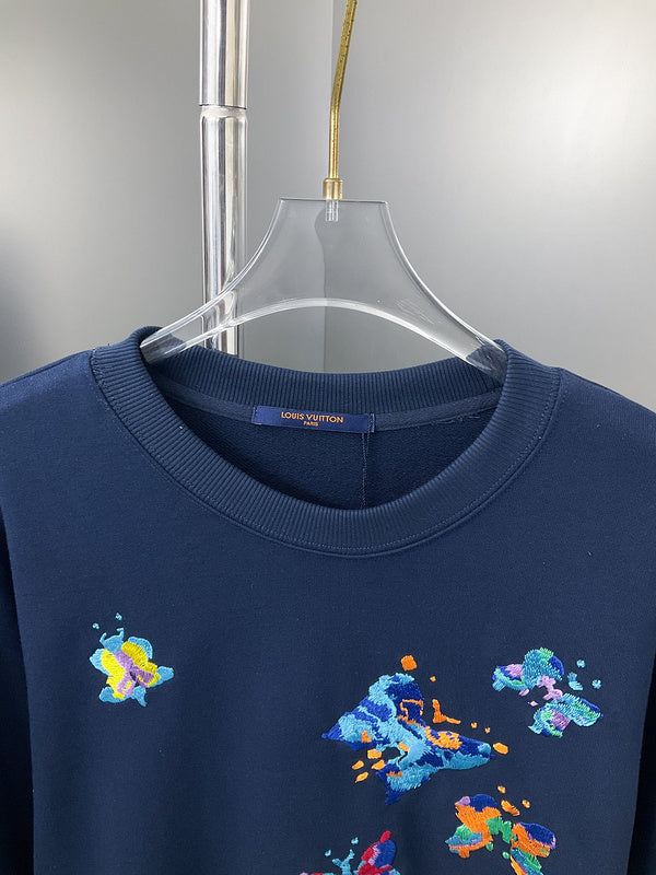 Close-up detail shot of Louis Vuitton luxury clothing with label-forward styling