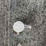 Close-up detail shot of Louis Vuitton luxury clothing with monogram-inspired silhouette