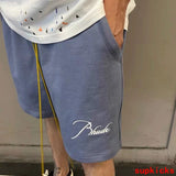 Side profile of Rhude luxury clothing with logo-detail design