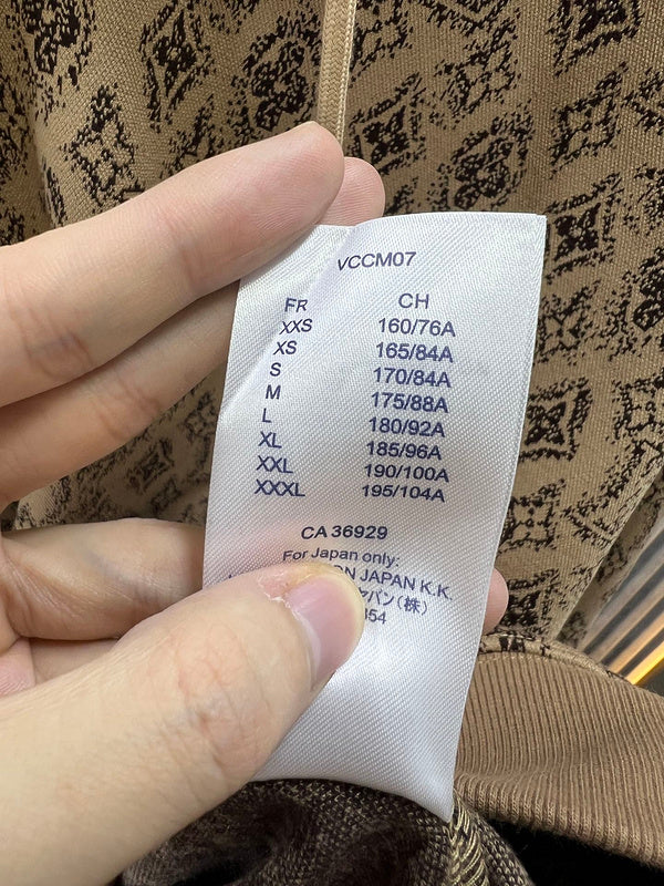 Close-up detail shot of Louis Vuitton luxury clothing with logo-detail design
