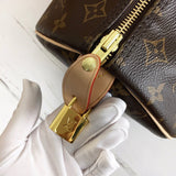Side profile of signature polished women's handbag – women's luxury handbag