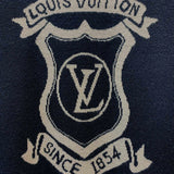 Flat lay presentation of Louis Vuitton luxury clothing with label-forward styling