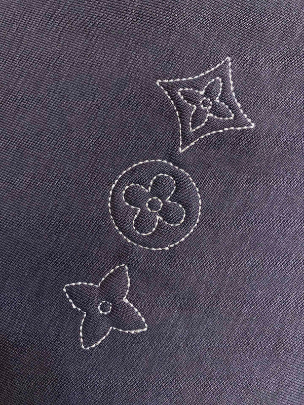 Flat lay presentation of Louis Vuitton luxury clothing with runway-inspired design