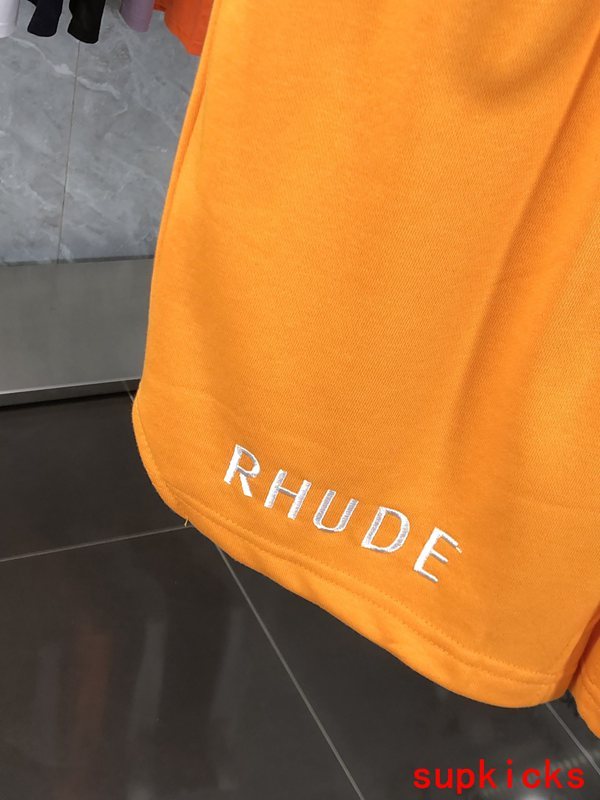 Flat lay presentation of Rhude luxury clothing with label-forward styling