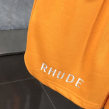 Flat lay presentation of Rhude luxury clothing with label-forward styling