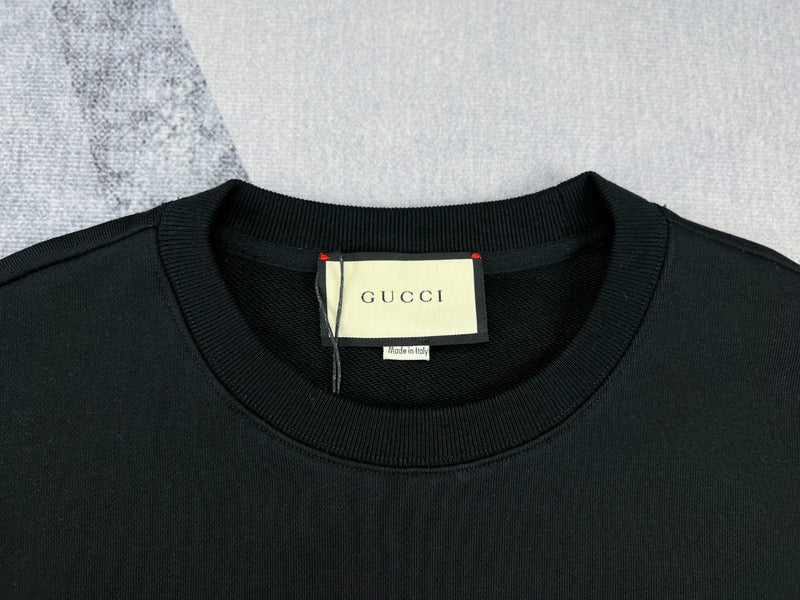 Close-up detail shot of Gucci luxury clothing with signature branding