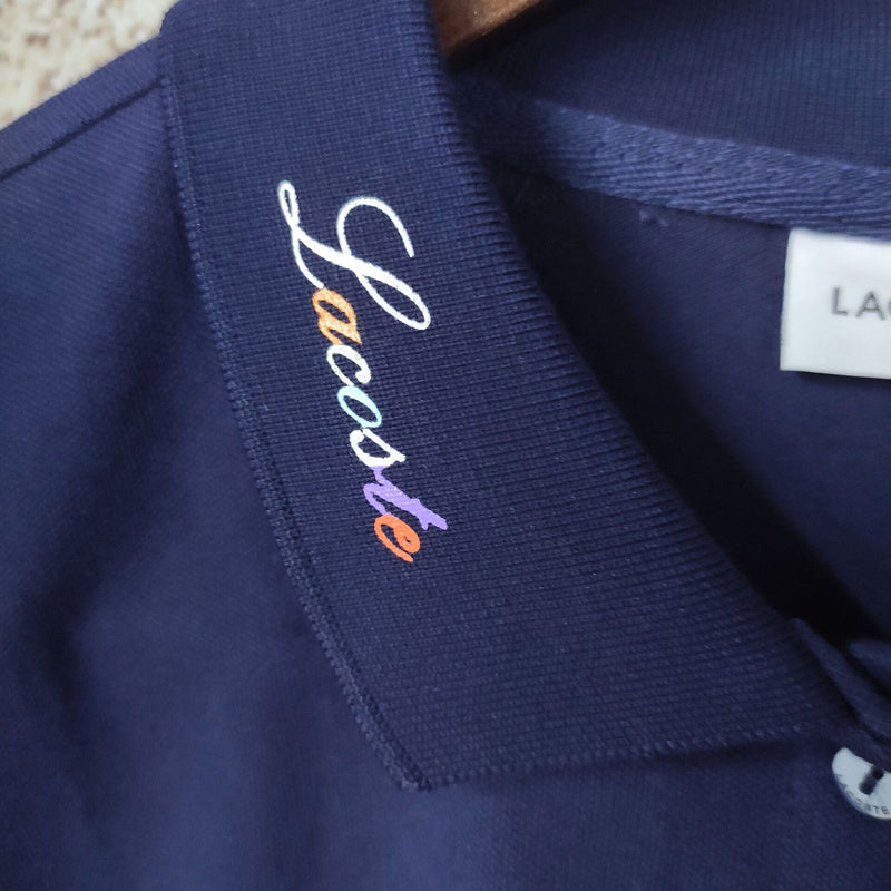 Flat lay presentation of Lacoste luxury clothing with signature branding