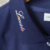 Flat lay presentation of Lacoste luxury clothing with signature branding