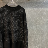 Flat lay presentation of Louis Vuitton luxury clothing with label-forward styling