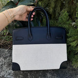 Side view of streamlined structured handbag