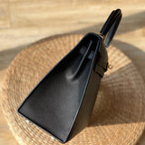  Effortless top-handle bag carried on shoulder