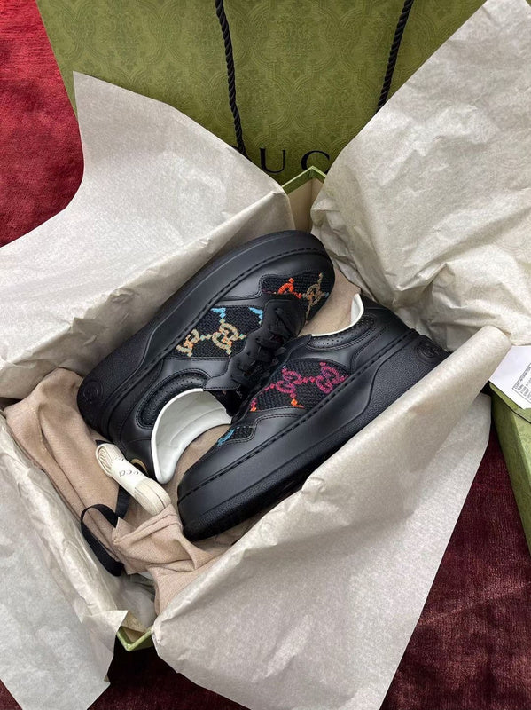 Side profile of Gucci all-black sneakers retro runner design