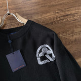 Close-up detail shot of Louis Vuitton luxury clothing with logo-detail design