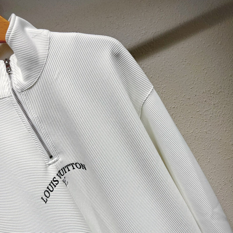 Flat lay presentation of Louis Vuitton luxury clothing with monogram-inspired silhouette