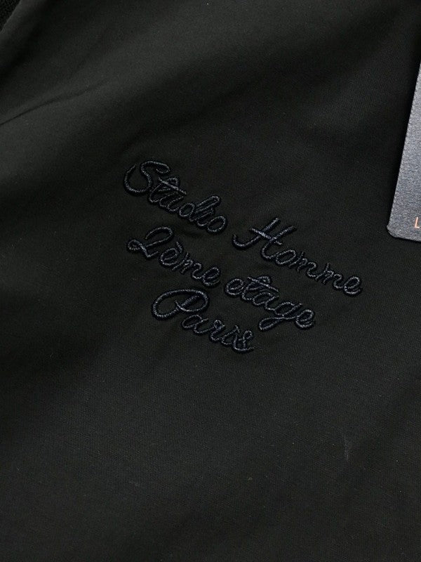 Flat lay presentation of Louis Vuitton luxury clothing with signature branding