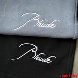 Flat lay presentation of Rhude luxury clothing with everyday silhouette