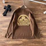 Close-up detail shot of Louis Vuitton luxury clothing with logo-detail design