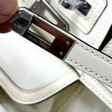 Side view of fluid structured handbag