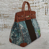  Signature handbag carried on shoulder