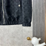 Close-up detail shot of Louis Vuitton luxury clothing with label-forward styling