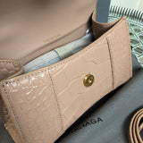 Side profile of polished elevated women's handbag – women's luxury accessory