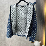 Close-up detail shot of Louis Vuitton luxury clothing with label-forward styling