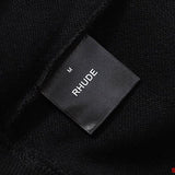 Side profile of Rhude luxury clothing with signature branding