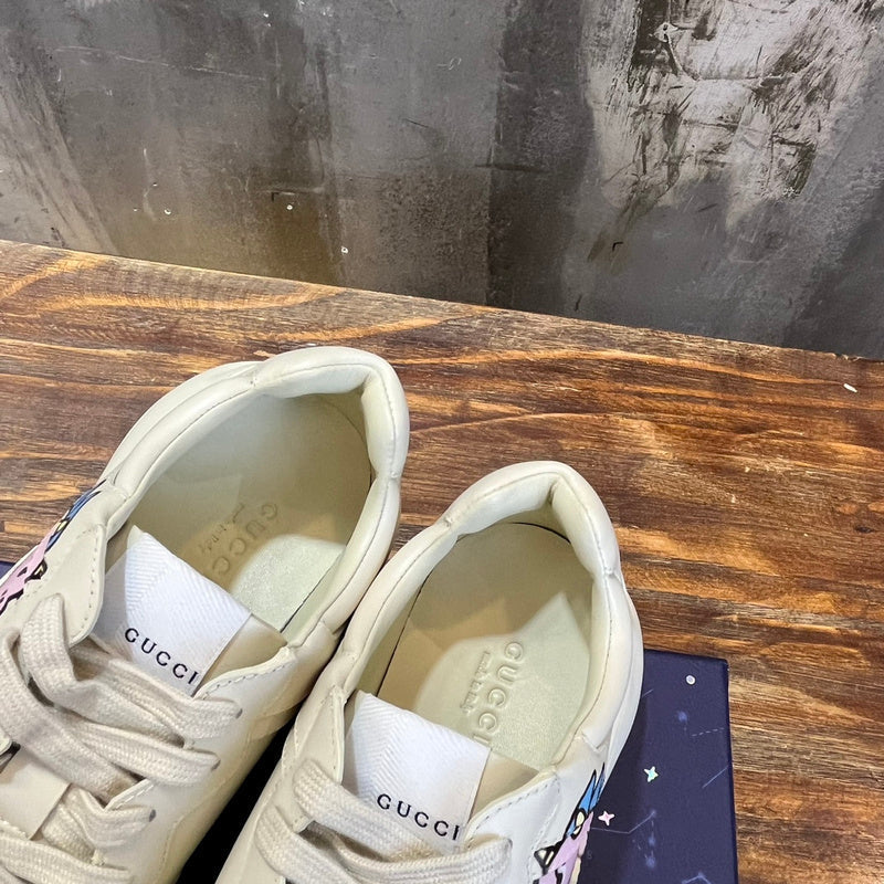 Side profile of Gucci two-tone sneakers signature lace-up style
