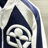 Close-up detail shot of Louis Vuitton luxury clothing with label-forward styling
