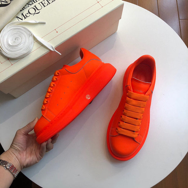 Side profile of Alexander McQueen bold contrast sneakers sleek tonal finish