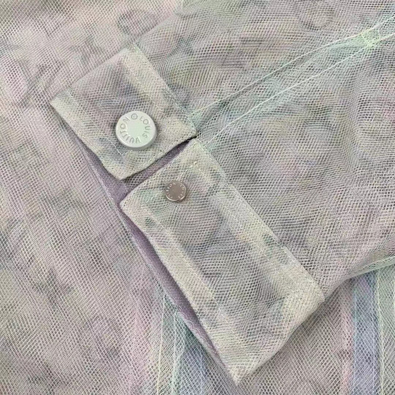 Close-up detail shot of Louis Vuitton luxury clothing with signature branding