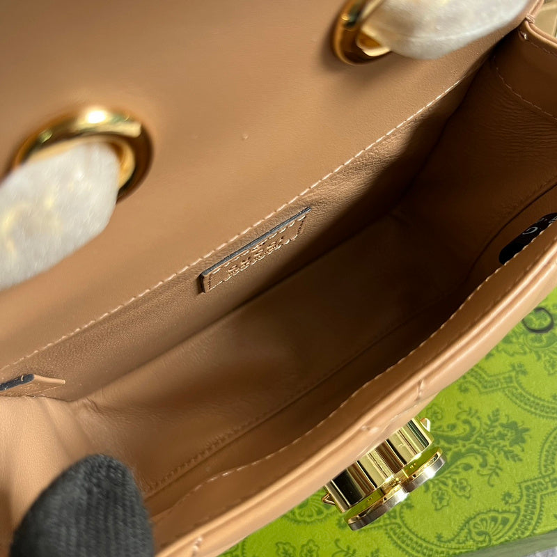 Handle and strap detail of classic polished women's handbag – women's designer-style accessory