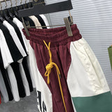 Flat lay presentation of Rhude luxury clothing with streetwear-inspired cut