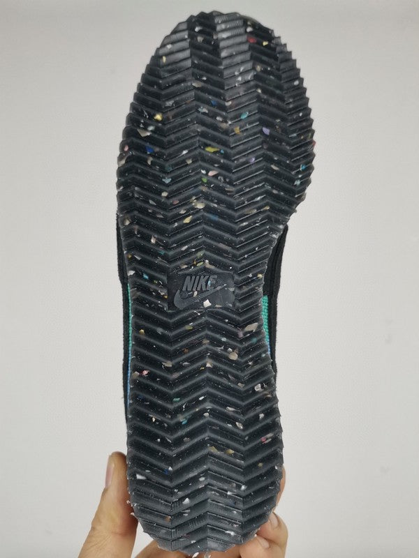 Side profile of Nike tonal black sneakers chunky sole construction