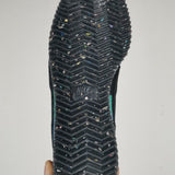 Side profile of Nike tonal black sneakers chunky sole construction