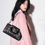 Side profile of elevated modern women's handbag – women's luxury accessory