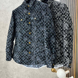 Close-up detail shot of Louis Vuitton luxury clothing with label-forward styling