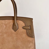  Contemporary top-handle bag carried on shoulder