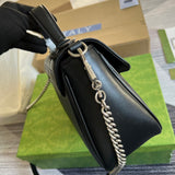 Handle and strap detail of structured polished women's handbag – women's statement bag
