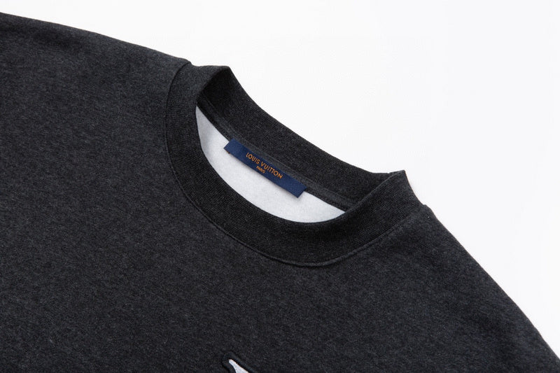 Close-up detail shot of Louis Vuitton luxury clothing with signature branding