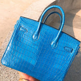  refined top-handle bag styled with outfit