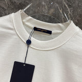 Side profile of Louis Vuitton luxury clothing with label-forward styling