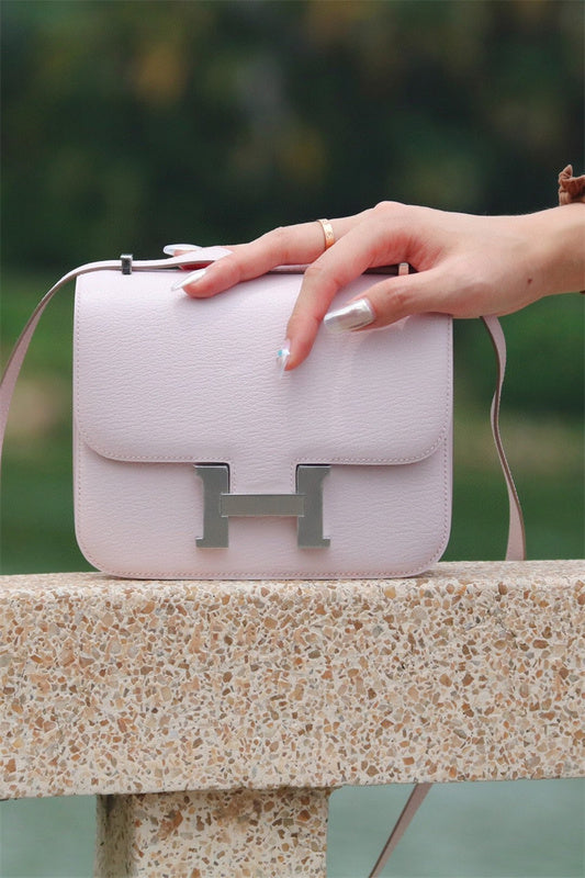  Timeless top-handle bag carried on shoulder