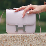  Timeless top-handle bag carried on shoulder