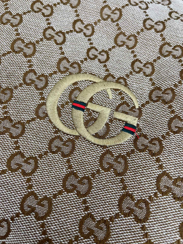 Close-up detail shot of Gucci luxury clothing with monogram-inspired silhouette